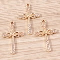 Detail of three gold alloy infinity cross pendants with sparkling inlaid rhinestones - Gold Infinity Cross (YD1491)