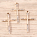 Detailed view of three gold-plated cross pendants with inlaid rhinestones on wood - Gold Cross (YD1492)