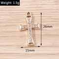 Detailed view of a gold cross pendant with rhinestones measuring 26mm by 15mm dimensions - Gold Cross (YD1494)