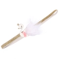 Detailed view of baby headband with golden glitter band, white swan and feather decor - MB746 Swan Headband