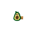 Handmade crochet avocado hair clip with cute cartoon face on white background - Avocado