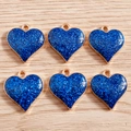 Close-up of six dark blue glitter heart pendants with gold metal edges for DIY jewelry - Royal Blue