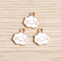Close-up of three cute white cloud pendants with smile faces on wooden background - White