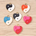 Close-up of heart-shaped Yin Yang enamel charms with golden borders for DIY jewelry - 10 Pieces Pack / Mixed Color Heart Tai Chi