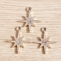 Detailed view of three silver-plated eight-pointed star charms with sparkling rhinestones - 10 Pieces/Pack / Gold
