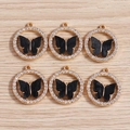 Dettaglio di ciondoli a farfalla dorati con strass scintillanti e smalto nero per gioielli DIY - Tondo Strass Nero (YD650heise)