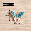 Dettaglio ciondolo farfalla dorata con smalto blu, strass e dimensioni del prodotto - Dimensioni vedi dettagli / Stile Farfalla Smalto Blu e Bianco con Strass (YD002lanse) / Confezione da 10 / Blu