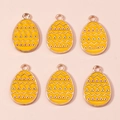 Detail of yellow Easter egg pendants with wave patterns and rose gold metal edges - Yellow Geometric Egg (1081)