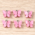 Detail of six pink butterfly charms with silver metal edges for DIY jewelry making - 10 Pieces Pack / Rose Red