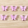 Macro detail of six pink resin butterfly pendants with silver metal frames for DIY jewelry - 10 Pieces Pack / Purple