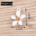 Macro detail of white flower charm with gold center showing dimensions and weight - White Five-Petal Flower Style (YD1104baise) / 1.9cm x 1.3cm / White