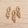 Detailed view of infinity alloy charms with white rhinestones and double rings for DIY - 20 Pieces Set / Gold