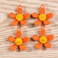 Detail view of four orange flower pendants with yellow centers on a wooden surface - Orange Five-Petal Flower Style (YD1105chengse) / 1.9cm x 1.6cm / Orange