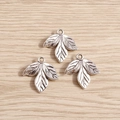 Macro shot of vintage silver leaf pendants with detailed veins for DIY jewelry making - Silver