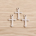 Polished silver cross charms with ring connector for DIY jewelry crafts on wood surface - 40Pcs Pack / Bright Silver