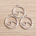 Minimalist silver circular wave pendants for DIY jewelry making displayed on a wooden surface - 20 Pieces Set / Silver