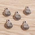 Detailed close-up of antique silver alloy shell pendants for DIY jewelry crafting - Antique Silver