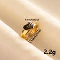 Macro shot of vintage gold heart ring with black enamel and dimensions on silk - Gold Band-Black Heart