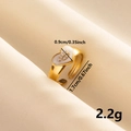 Macro detail of vintage gold heart ring with enamel eye design on beige velvet - Gold Band-White Heart