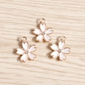Close-up of pink cherry blossom enamel pendants with small central rhinestone and gold alloy - 10 Pieces Pack / White