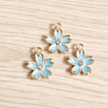 Close-up of blue enamel cherry blossom pendants with gold plating and zircon center - 10 Pieces Pack / Blue