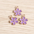 Detail of purple cherry blossom charms with gold plating and center rhinestone for DIY - 10 Pieces Pack / Purple