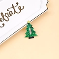 Detail of a glittery green Christmas tree hair clip with a yellow star on a ceramic tray - Christmas Tree Style (MC5818)