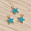 Macro shot of teal enamel star pendants with gold star accents on a wooden background - 10 Pieces Pack / Blue