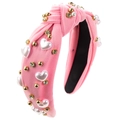 Close-up of pink knotted headband with heart-shaped pearls and sparkling rhinestones - Pink