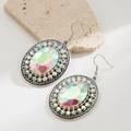 Macro shot van turquoise ovale oorbellen met strassteentjes en een retro zilveren afwerking - AB Regenboog Steen Witte Strass Stijl / Wit