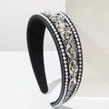 Detailed macro view of vintage baroque wide headband with pearls and rhinestones - Black