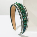 Close-up of luxury emerald green crystal and white pearl embellishments on wide headband - Green