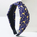 Detail of dark blue fabric knotted headband with yellow moon and star patterns - Blue