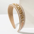 Close-up of wide baroque headband with intricate pearls and champagne crystal rhinestones - Brown