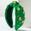 Détail du serre-tête en tissu vert avec des œufs de Pâques colorés et des strass brillants - Vert