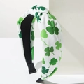 Close-up of Saint Patrick's Day headband with green clover patterns and top knot detail - White Green / White With Green Shamrock
