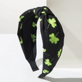 Detail of green shamrock pattern on black knotted headband for St. Patrick's Day - Black Leaf / Black with Green Clover