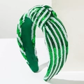 Detail of green and white sequined knotted headband with sparkling textures and wide design - White and Green Sequin
