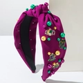 Detail of Mardi Gras headband with purple fabric, colorful pearls and festive charms - Purple