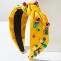 Detail of yellow Mardi Gras headband with colorful pearls and festive enamel charms - Yellow
