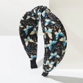 Detalle de la diadema con estampado de mariposas y diseño de nudo girado elegante - Negro Iridiscente