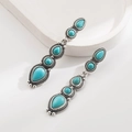 Bohemian style drop earrings featuring faux turquoise stones in a vintage silver finish - Green