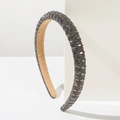 Detailed shot of sparkling grey rhinestone crystals on a padded luxury headband - Gray
