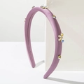 Detail of lavender padded headband with colorful rhinestones and floral bow design - Purple