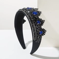 Dettaglio di gemme blu a goccia e cristalli su un cerchietto a corona nero vintage - Blu
