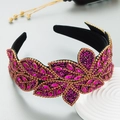 Detailed close-up of pink rhinestones and beads on a baroque wide velvet headband - Rose Red