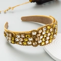 Detailed macro view of baroque wide headband featuring multi-color crystals on gold satin - Yellow