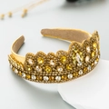 Golden Baroque crown headband with amber rhinestones on a white geometric stand - Yellow