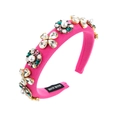 Detailed macro view of handmade pink fabric headband with rhinestones and white pearls - Rose Red