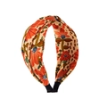 Detail showing vintage floral print fabric knot headband with orange flowers and green leaves - Beige Orange Floral (FG194) / Orange